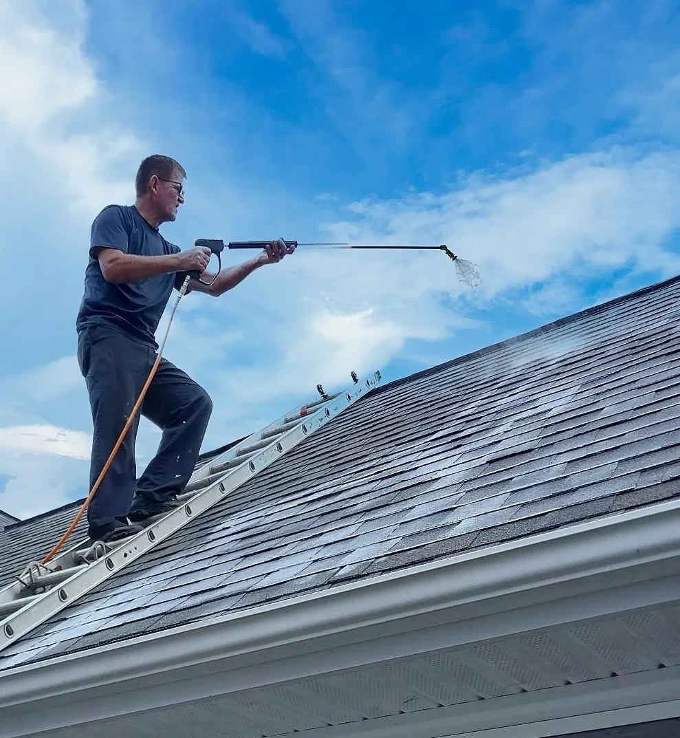 Technician spraying Shingle Serum onto asphalt shingles